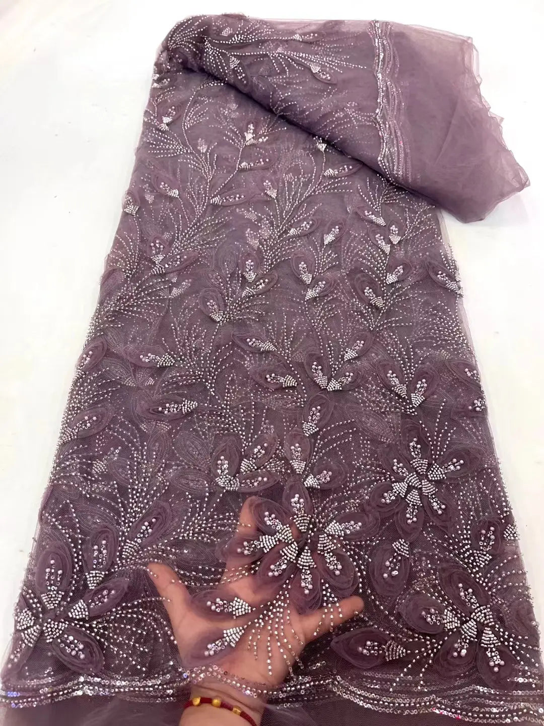a delicate dark purple ribbon flower beaded tulle lace fabric featuring intricate floral patterns with sparkling silver beads suitable for elegant garment design