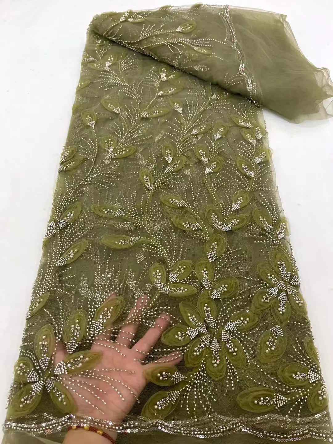 olive green sheer lace fabric featuring intricate floral embroidery and sparkling rhinestones in peach ribbon flower beaded tulle lace fabric with flower beaded tulle design