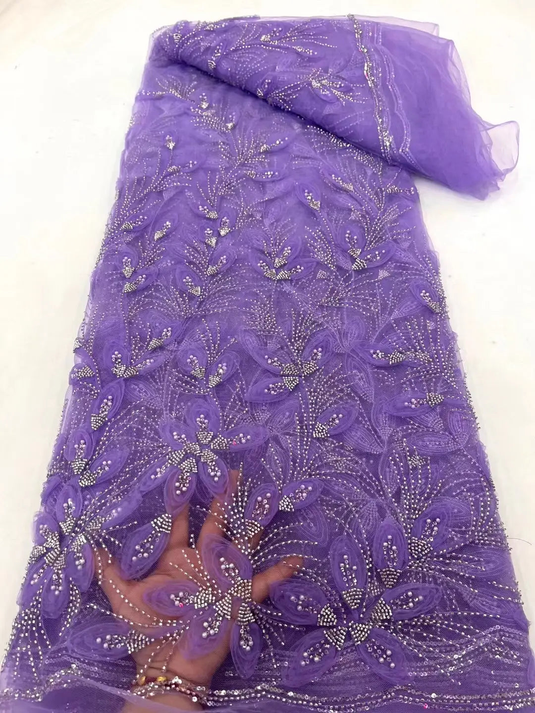 purple sheer ribbon flower beaded tulle lace fabric featuring intricate floral patterns and sparkling silver beads suitable for elegant garment design.