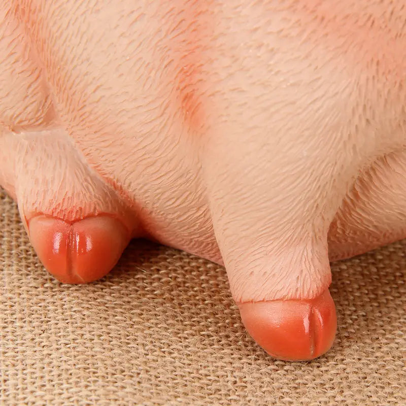 pink pig piggy bank with textured plastic skin and red toenails for use as a money box
