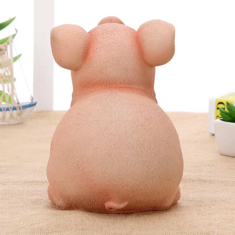 Pink pig piggy bank made of plastic with a textured slightly glossy surface serving as a money box.