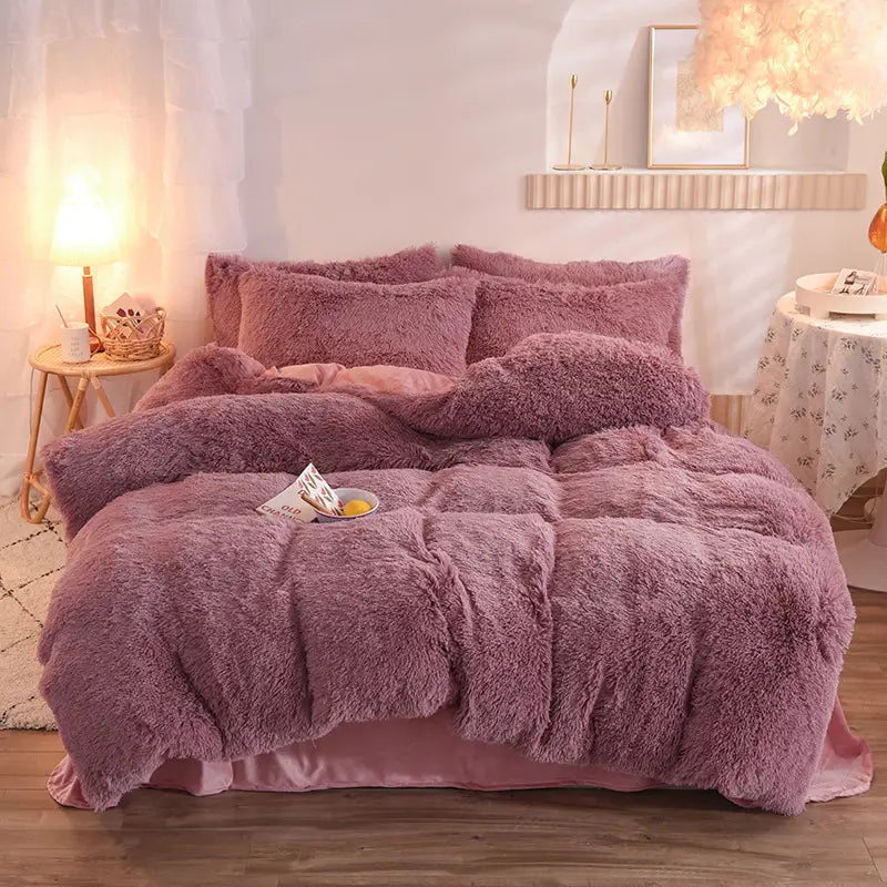 pink fluffy faux fur plush duvet cover set featuring a fluffy mauve quilt cover with a soft textured surface and matching pillows.