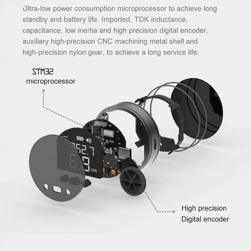 Black circular digital electronic measuring ruler with exposed internal components including microprocessor and precision gears.