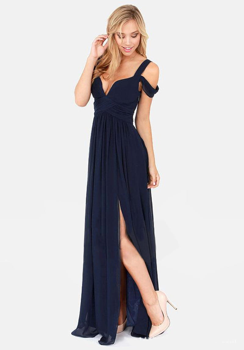 A navy blue floor length elegant maxi dress with an off-the-shoulder design, deep v-neckline, and a high slit inspired by greek style.