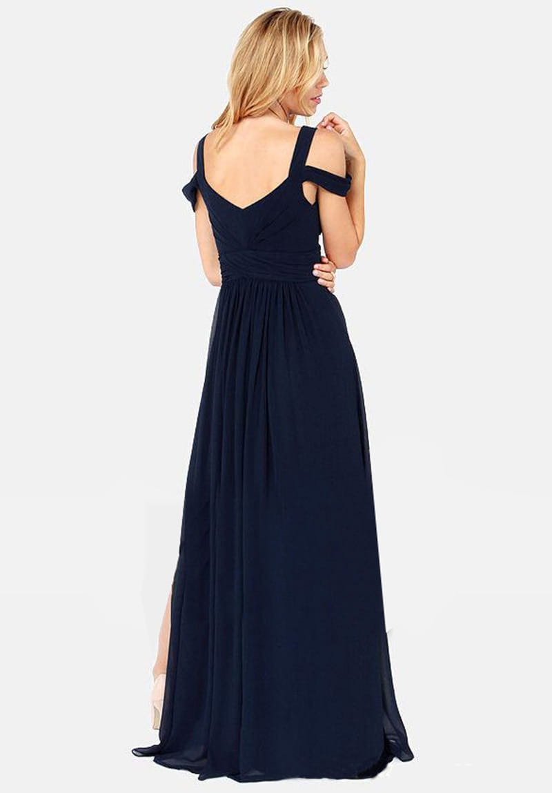 A navy blue chiffon floor length elegant greek style maxi dress with a v-neckline, off-the-shoulder straps tied into bows, and a high slit on one side.
