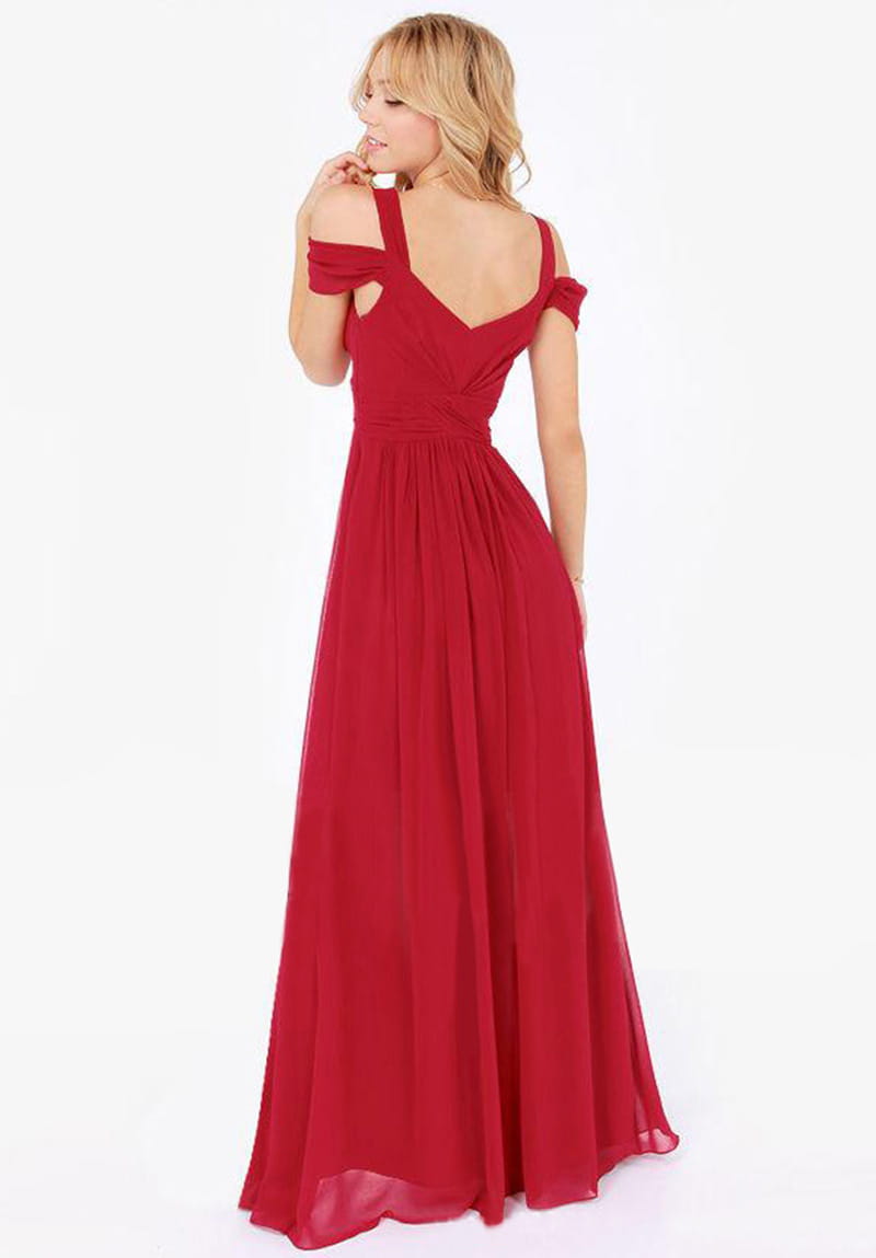 A flowing red chiffon floor length elegant greek style maxi dress with off the shoulder straps and a v neckline.