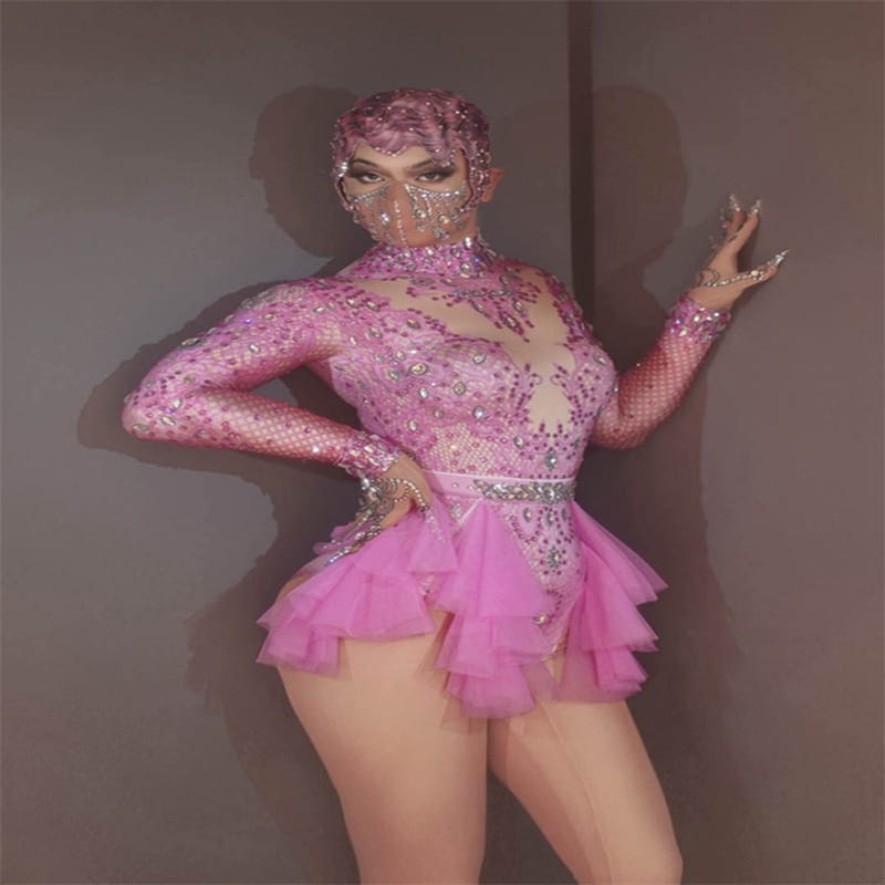 A sparkling pink sequined sexy shiny rhinestone mesh performance leotard with a ruffled skirt and matching face mask designed for dance.