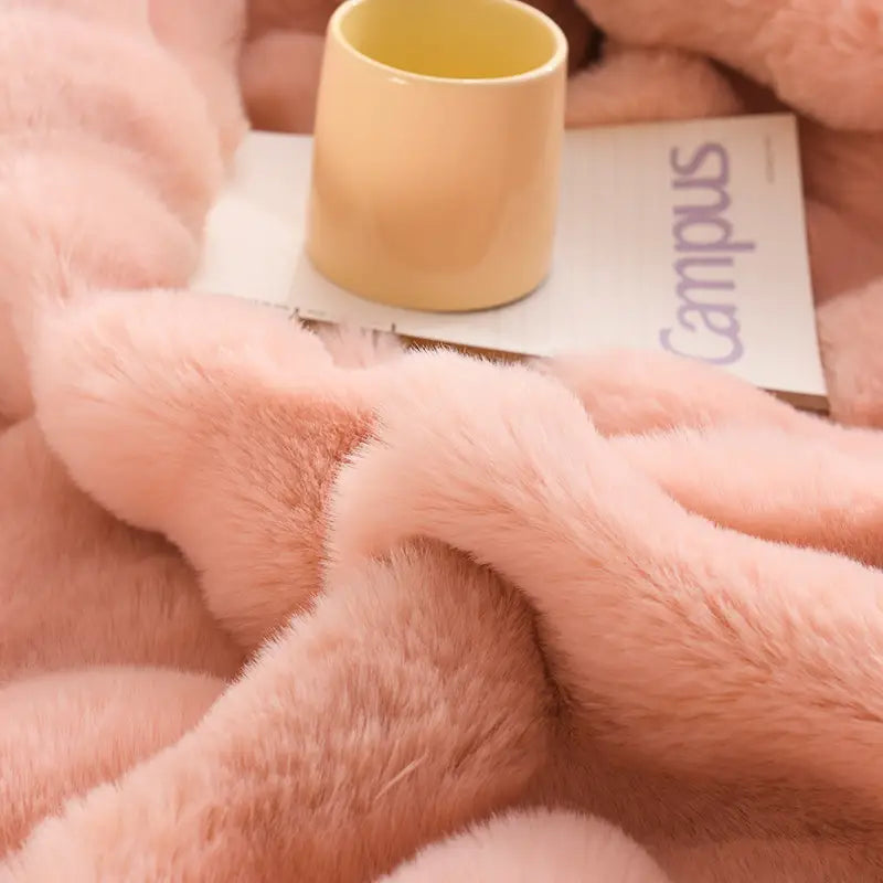 Soft pink velvet blanket thickened with a plush textured surface made of faux rabbit velvet for a cozy throw.