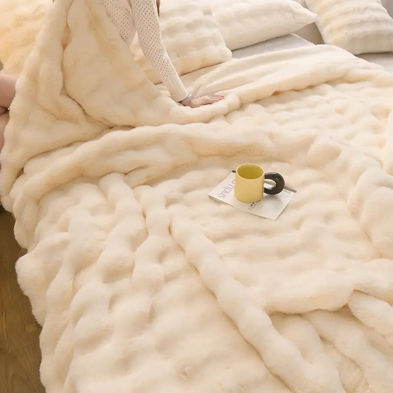 cream-colored ultra-soft chunky knit throw blanket with a plush textured surface featured in a beige rabbit velvet blanket thickened faux fur throw design.