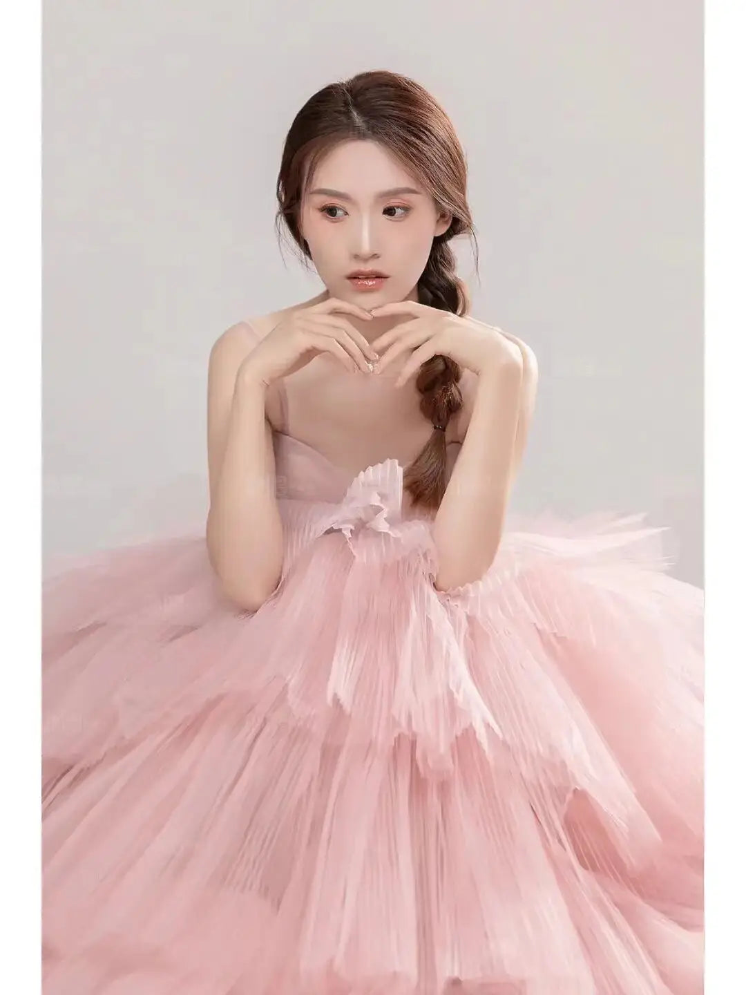 a soft pink layered tulle wedding photography dress with a delicate floral accent at the waist ideal as a photography dress pink and dress pink white option