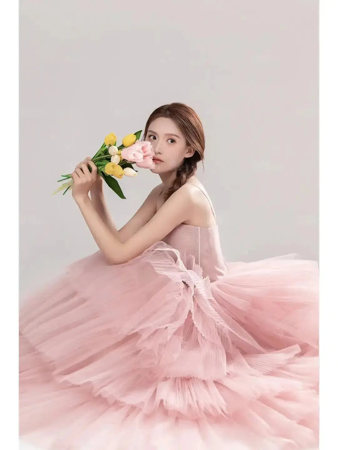 A soft pink tulle wedding photography dress featuring a layered voluminous skirt and delicate shoulder straps perfect for photography dress pink or dress pink white occasions.