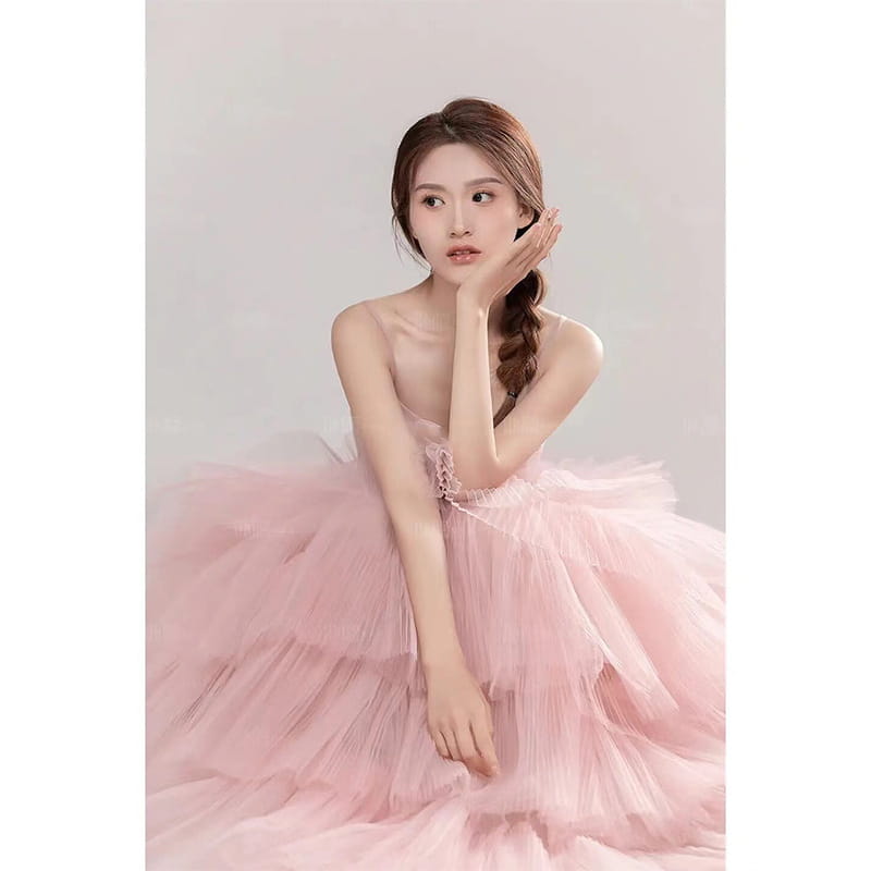 A soft pink multi-layered tulle wedding photography dress with delicate lace detailing at the bodice perfect for photography dress pink looks.