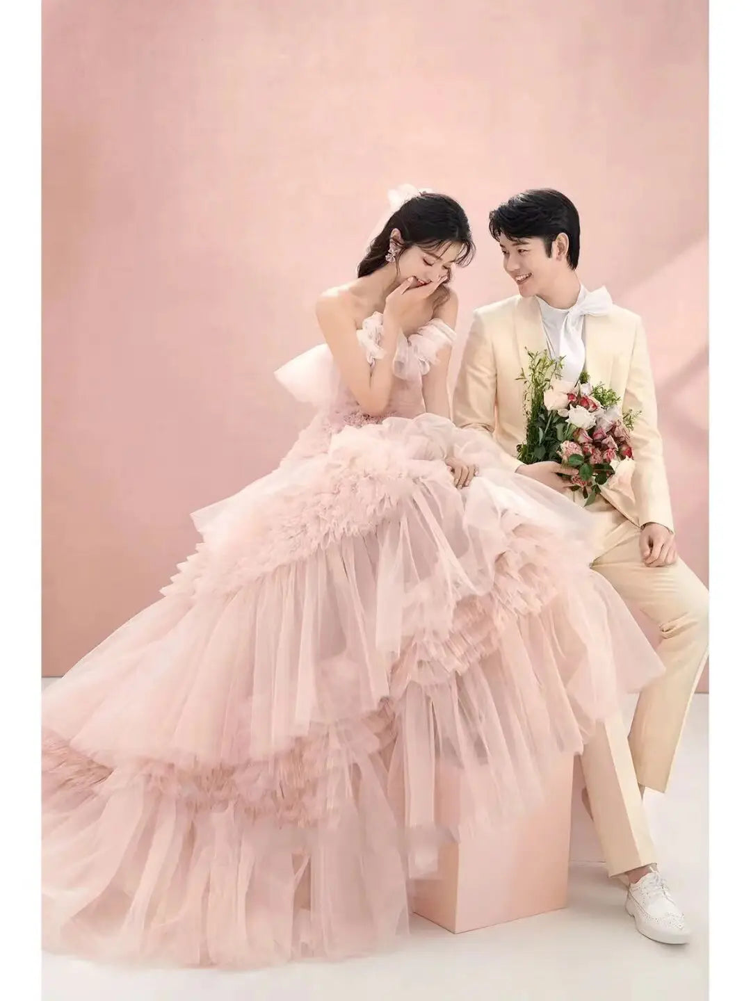 A delicate blush pink street photography pettiskirt made of colored mesh featuring layered ruffles and a sweetheart neckline.