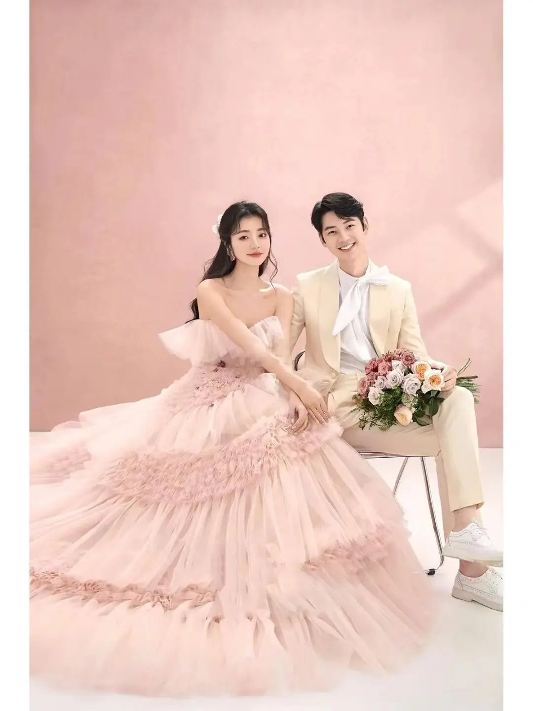 a flowing multi-tiered blush pink photography pettiskirt colored mesh dress made of tulle with delicate floral appliqués and a sweetheart neckline