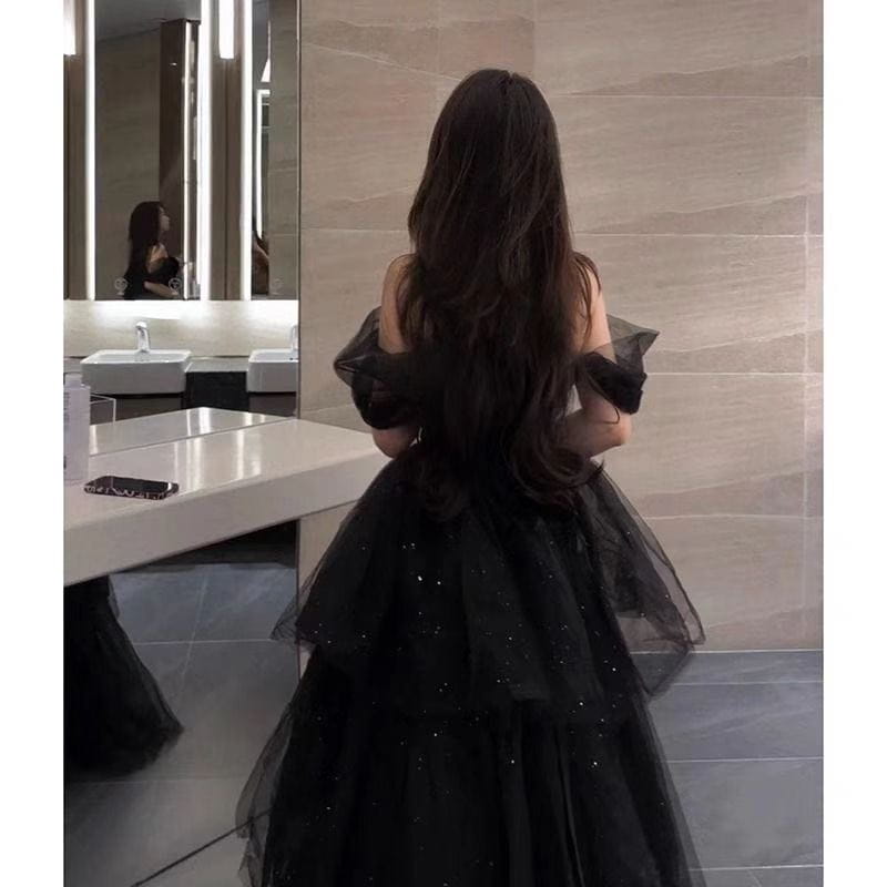 black velvet and tulle light luxury evening dress featuring a black evening dress with off the shoulder ruffled sleeves and a layered sparkly skirt for an elegant dress light luxury look