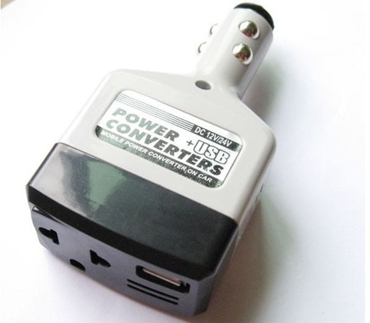Silver and black power supply car transformer with usb ports for mobile devices designed for car transformer mobile use.