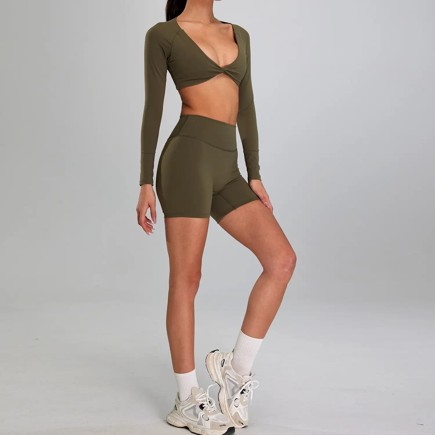 olive green long-sleeved crop top with twisted front design and matching high-waisted shorts designed as a sports suit outdoor running set suitable for outdoor running nude activities