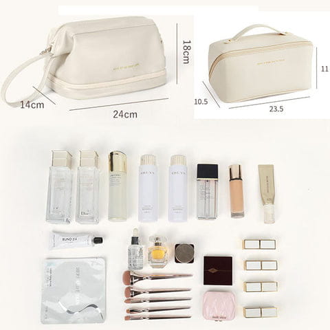 Cream-colored blush pink large capacity travel cosmetic bag with soft texture, top handle, and zipper closure for travel cosmetic use.