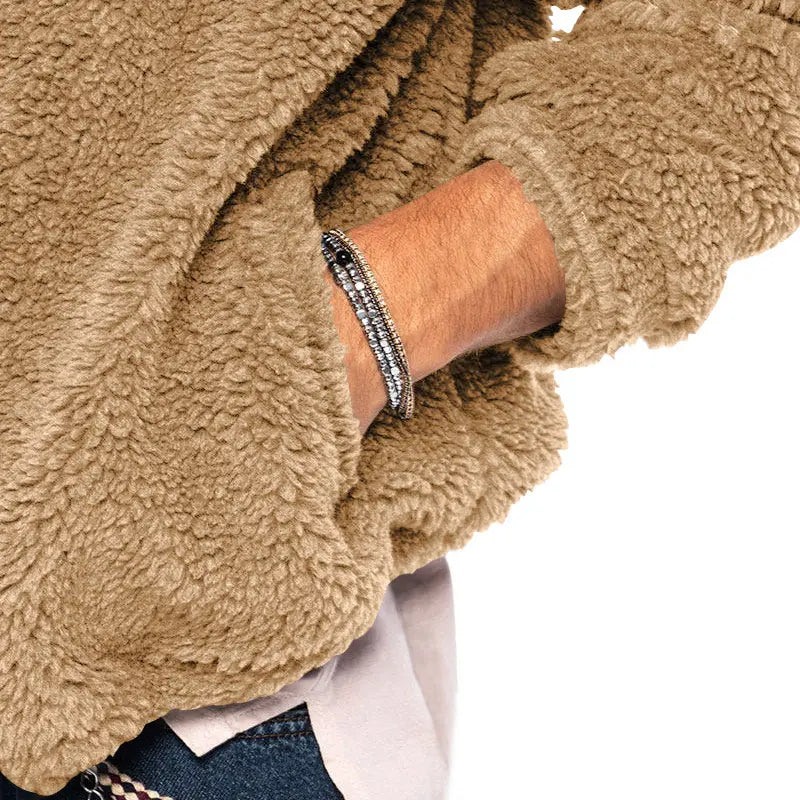 a sleek silver-toned bracelet with sparkling stones and black accents paired with a navy plush hooded jacket featuring a zipper loose casual design for wear warm coat functionality