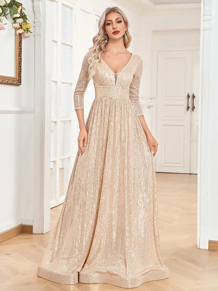 A shimmering champagne sequined high waist party formal dress featuring a floor-length design with a deep v-neckline and three-quarter sleeves.