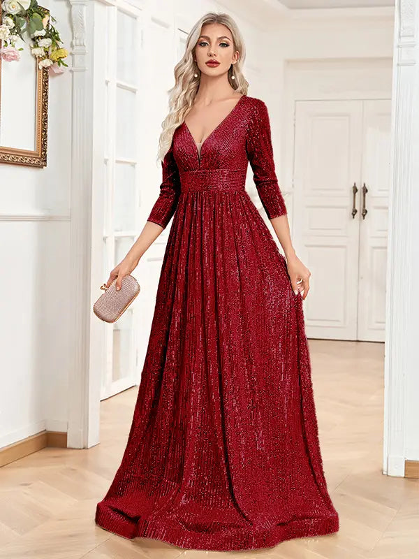 A shimmering red sequined evening gown with a deep v-neckline and three-quarter sleeves designed as a high waist party formal dress.