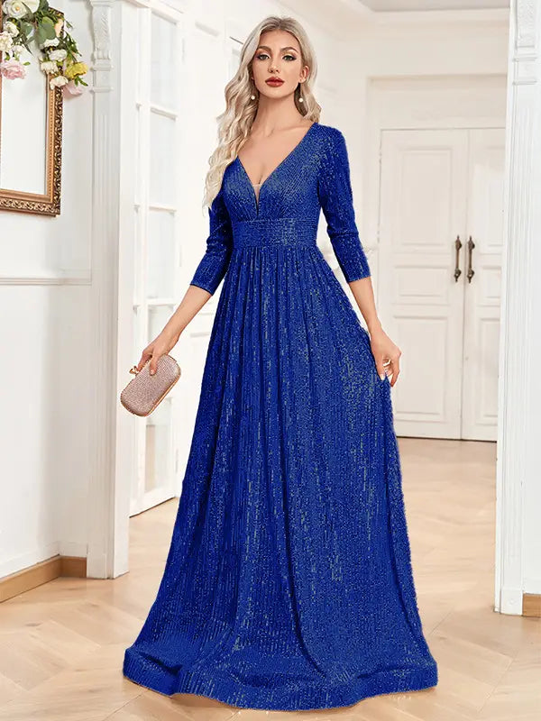 A shimmering royal blue sequined high waist party formal dress with a deep v-neckline and three-quarter sleeves.