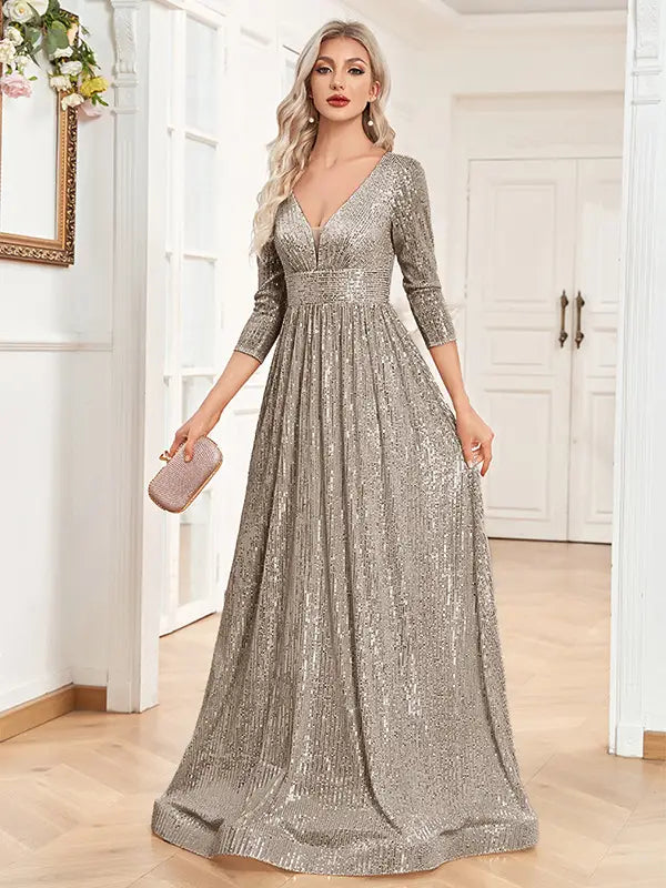 a shimmering silver sequined evening gown with a high waist party design, deep v-neckline, and three-quarter sleeves, ideal as a waist party formal dress
