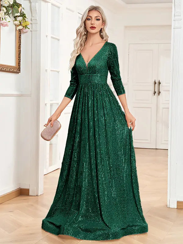 Emerald green sequined floor-length gown with three-quarter sleeves and v-neckline designed as a high waist party formal dress.