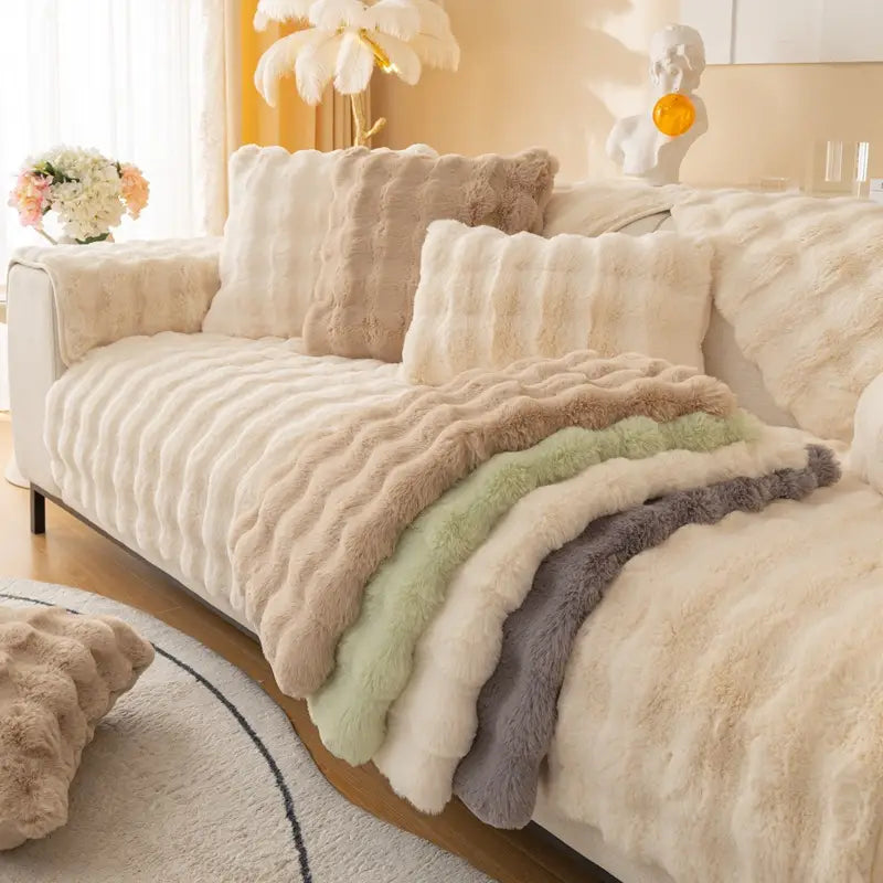 A plush ribbed faux fur sofa cushion in soft beige featuring a winter thickened rabbit plush texture for added warmth and comfort.
