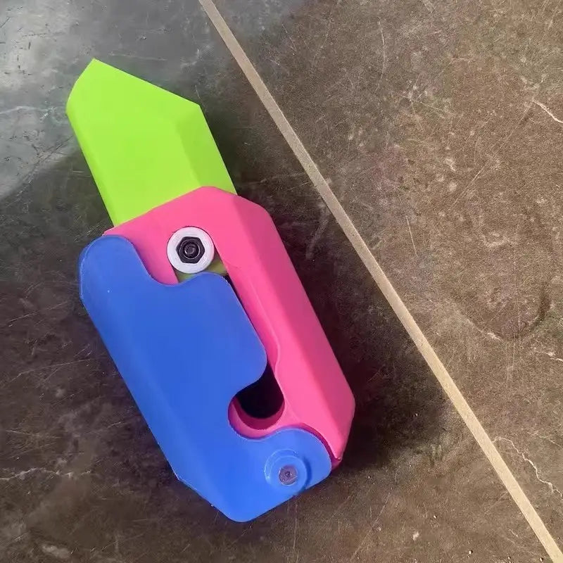 pink and lime radish knife gravity cub toy with a brightly colored plastic lime green blade and pink and blue handle designed for gravity cub jumping and printing gravity cub activities