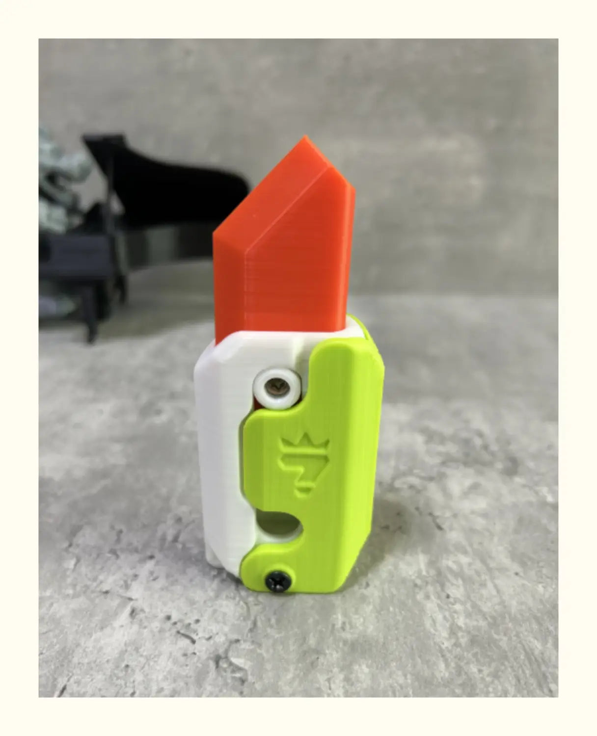 vibrant orange and lime green plastic radish knife with white accent and engraved crown logo designed for printing gravity cub and gravity cub jumping.