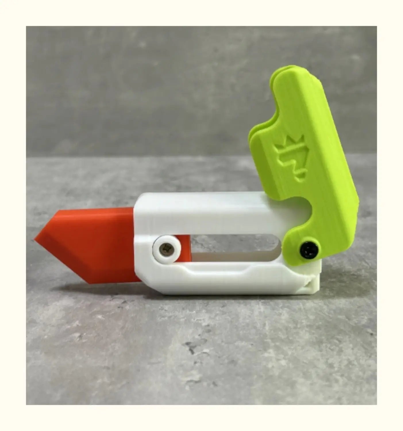 Bright lime green and white plastic radish knife with a red blade and ergonomic handle design for use with the pink and lime radish knife printing gravity cub toy.