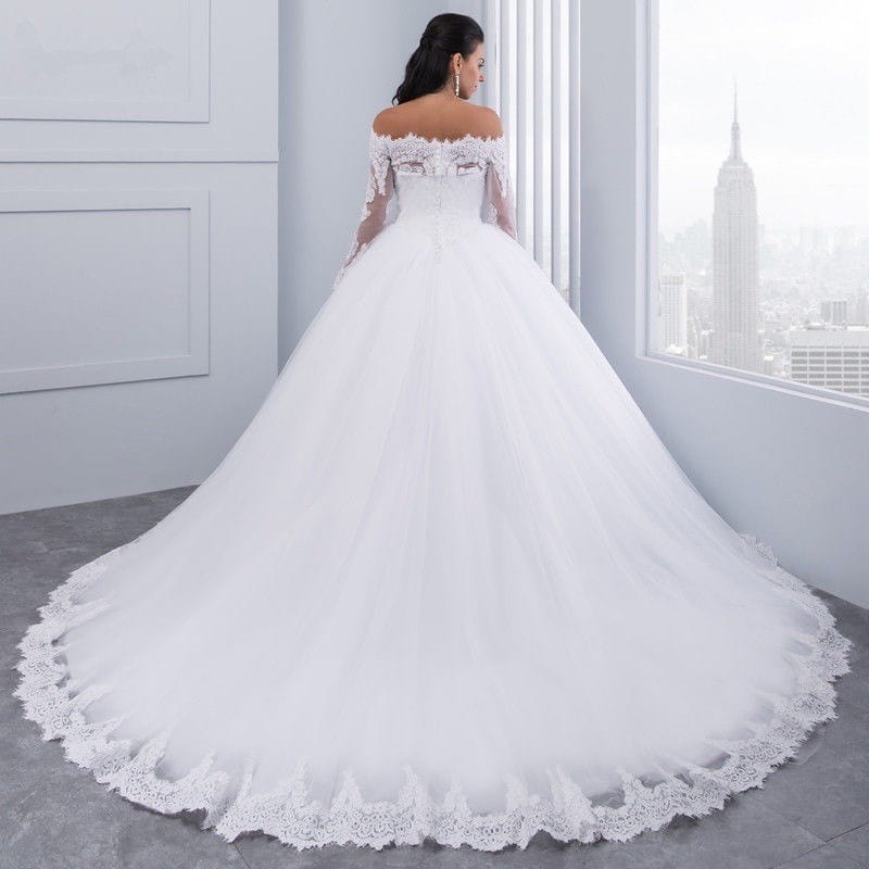 a white off-the-shoulder bridal wedding lace gown with long sheer sleeves and intricate lace detailing along the neckline, bodice, and hemline.
