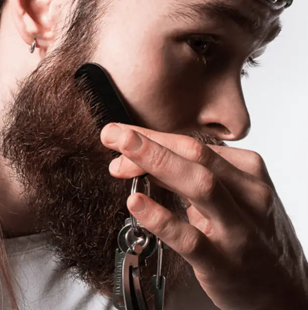 black plastic beard growth comb with keychain attachment for beard care included in beard growth kit with serum and dermaroller