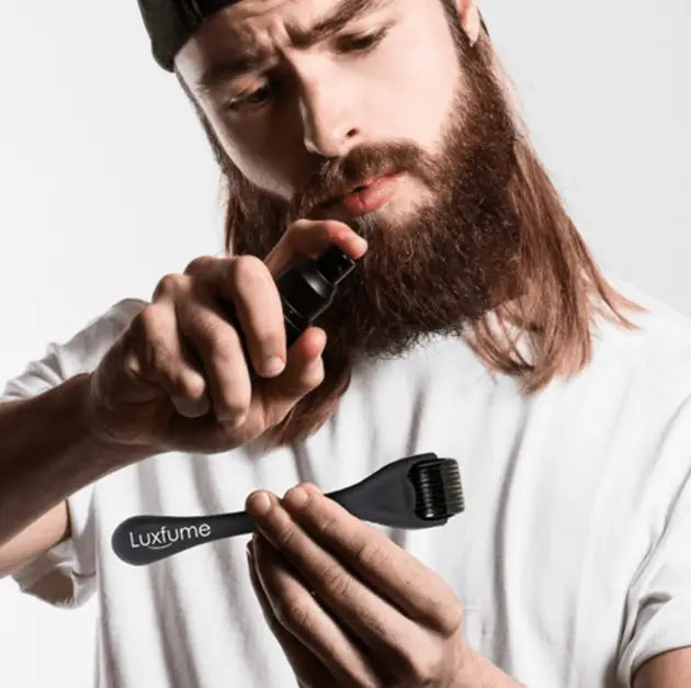 black luxfume beard dye applicator with brush head and spray nozzle for beard growth liquid in a beard growth kit with serum and dermaroller designed for beard care.