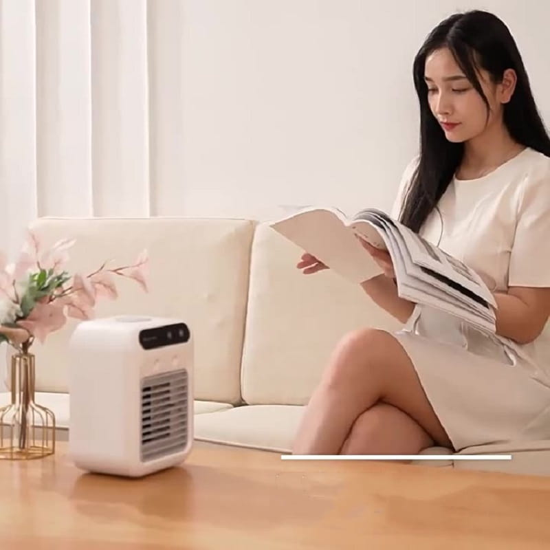 White portable air conditioner mini cooler fan with a sleek rectangular design and black control panel is a compact air cooler for personal use.