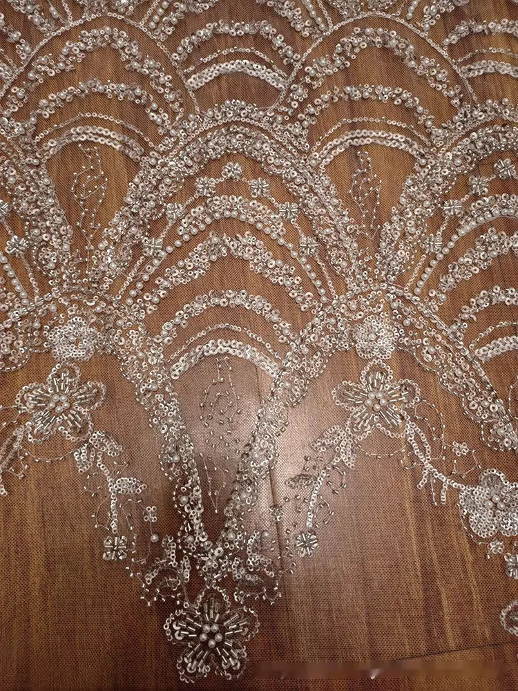 silver sequined lace fabric with intricate floral and wave style sequin bead patterns for wedding dress design