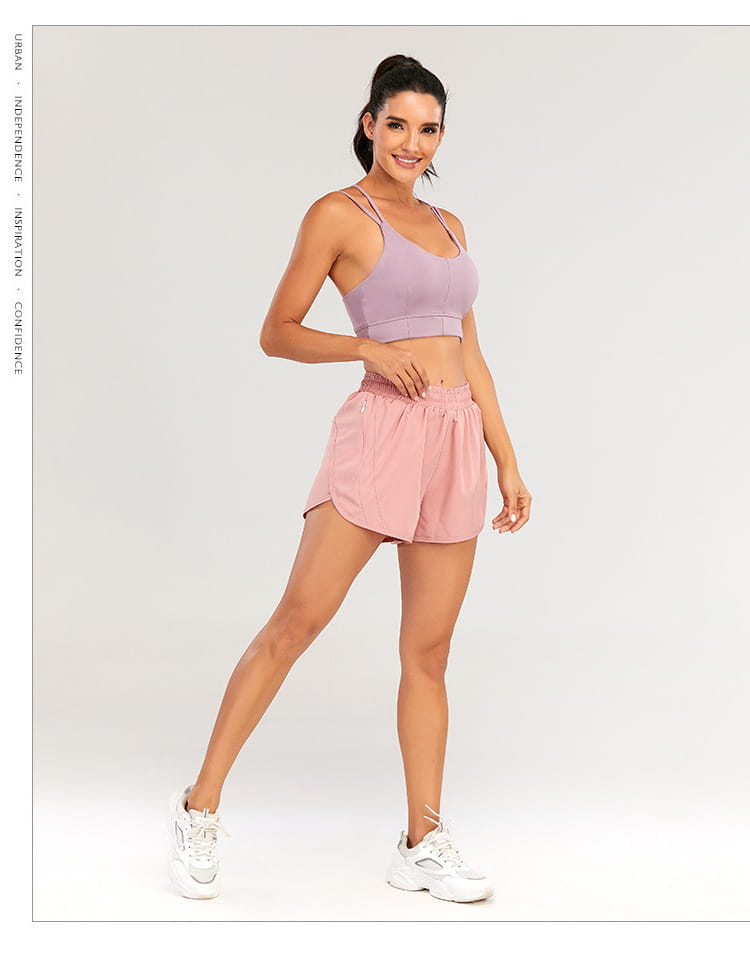 a soft lavender sports bra with thin spaghetti straps and a flattering cropped fit paired with light blue summer sports shorts featuring zipper pockets breathable for active use.