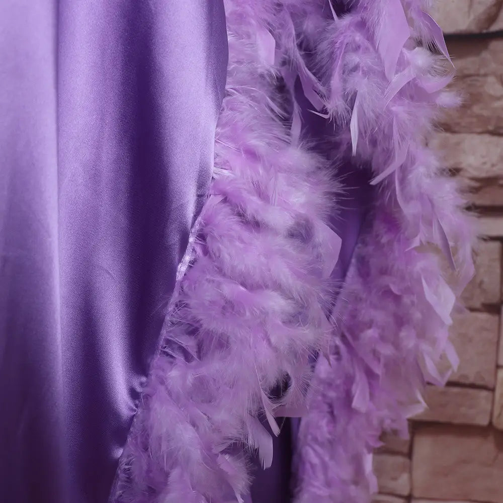 a loose dress luxury robe featuring a soft lavender feather boa with a plush, fluffy texture and delicate feathery strands fully surrounded by luxurious orange feathers