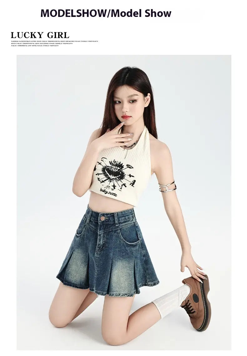white halter top with black embroidered sunburst design paired with a vintage denim skirt in high waist cream halter set