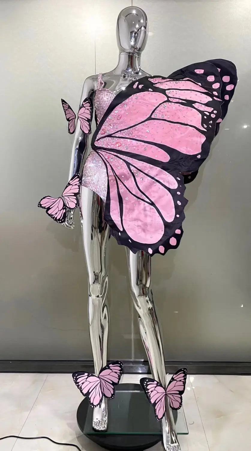 silver mannequin displaying a pink and black sequin butterfly latin dance skirt with glittery texture made from net yarn stretch fabric