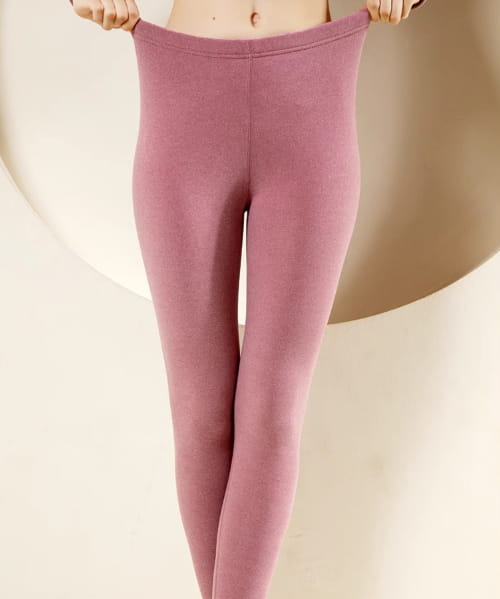 a pair of mauve-colored women’s warm cashmere fleece lined thermal leggings with a smooth stretchy fabric and high-waisted design ideal for warm cashmere winter wear