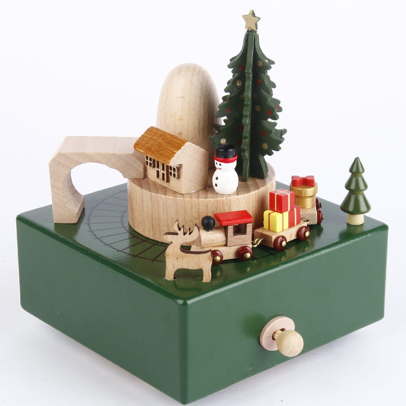 Green wooden diy dancing music box featuring a miniature Christmas scene with painted trees, a snowman, and a toy train.