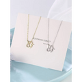 Two delicate 18k gold plated and silver toned rabbit pendant necklaces with crystal embedded charms and carrot detail