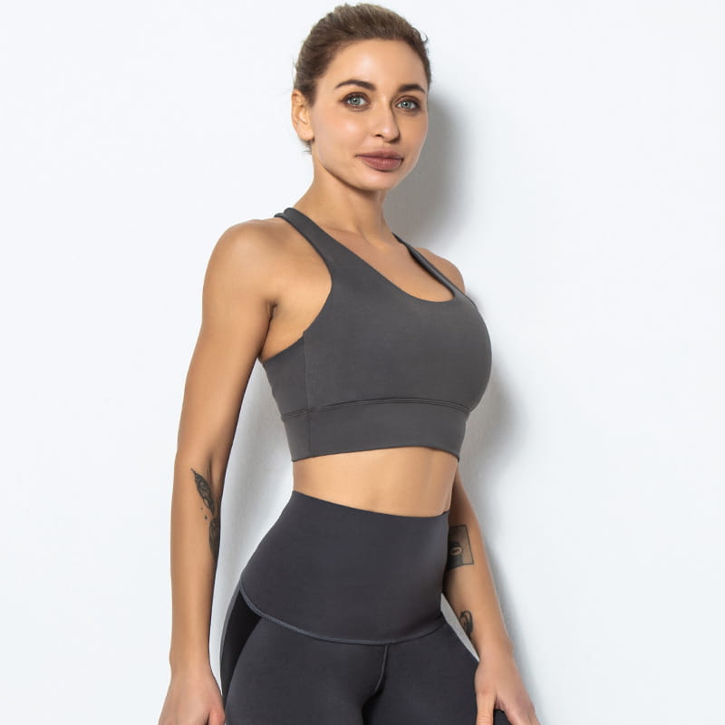 a sleek dark gray seamless women’s shockproof running sports bra with a racerback design for shockproof running and yoga activities