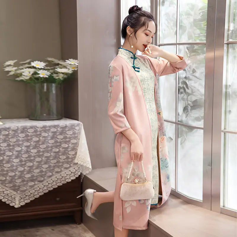 medium length cheongsam floral dress set featuring a delicate pink floral-patterned qipao with light green inner lining, teal frog closures, and a matching pearl-handled clutch.