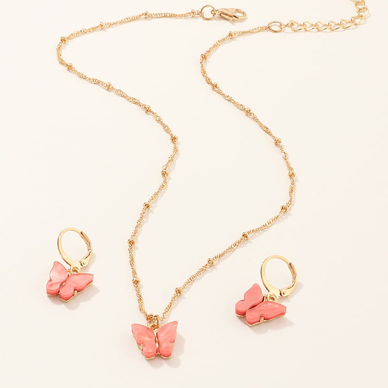 Gold-toned fashion resin butterfly necklace and earring set with coral-pink enamel wings on delicate chain links.