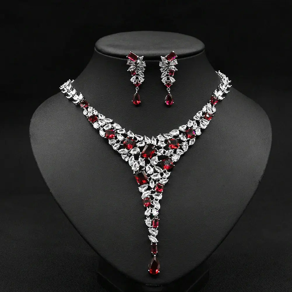 Elegant red and clear crystal colorful zircon necklace set featuring a v-shaped design with leaf motifs and matching earrings in a zircon necklace set.
