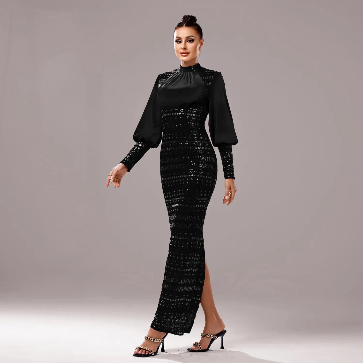 Black sequined mermaid gown with long sleeve round neck and sheer long sleeves in lace material for elegant evening wear.