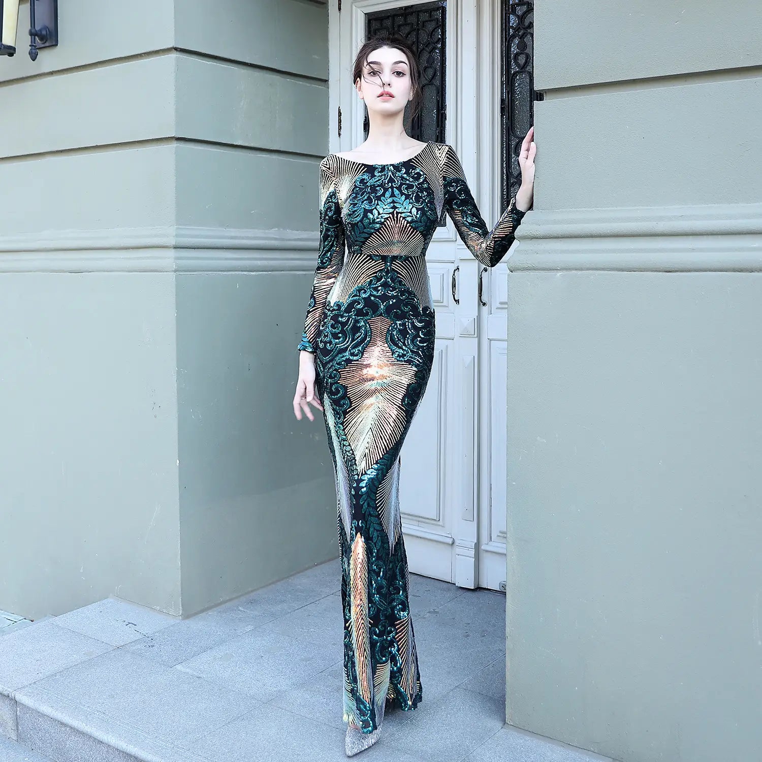 a shimmering emerald and gold sequined stitching mopping long gown with a fitted silhouette, long sleeves, and intricate floral patterns